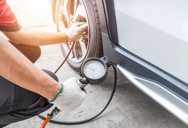 TIRE INFLATION - a person filling a tire with air