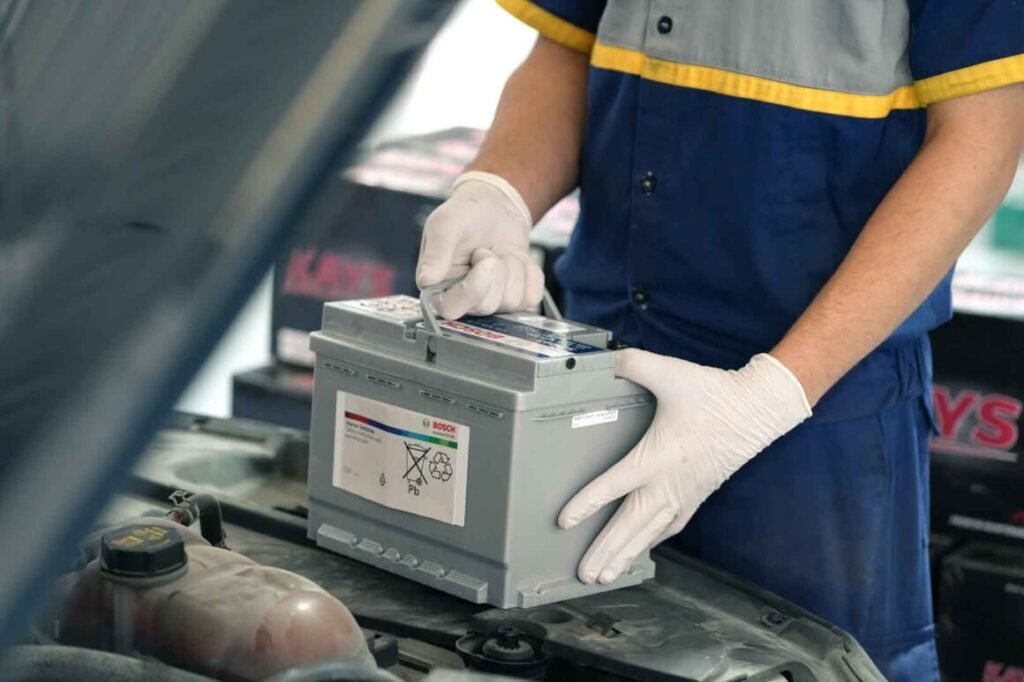 BATTERY INSTALL - Battery Installation a person installing a car battery