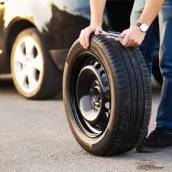 Spare Tire Delivery - a person installing a tire