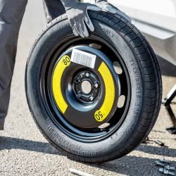 Spare Tire Install - a person holding a spare tire